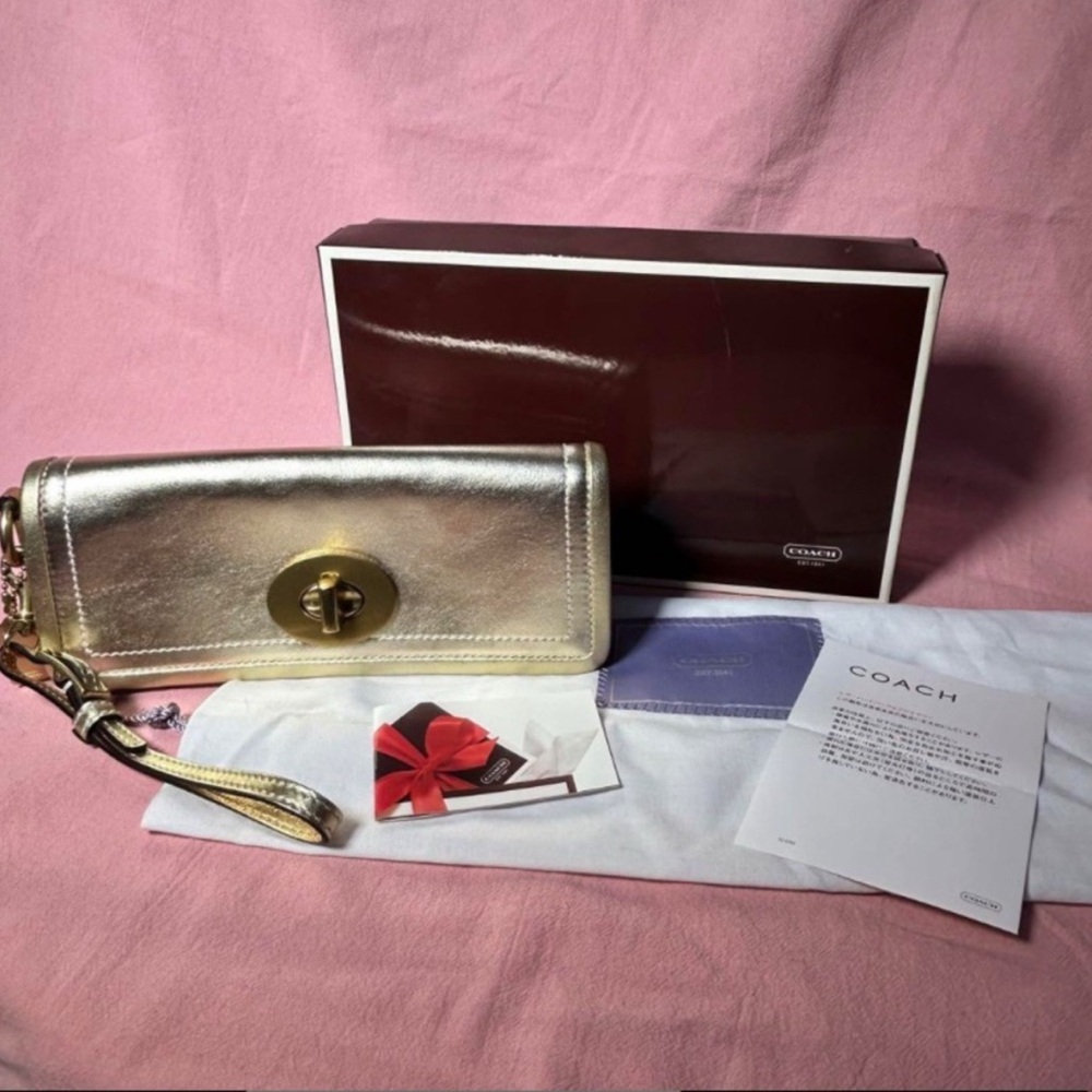 Coach Zoe wristlet clutch in a metallic finish.